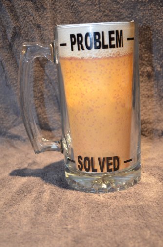 Novelty beer mug with Problem defined at top and Solved at the bottom.